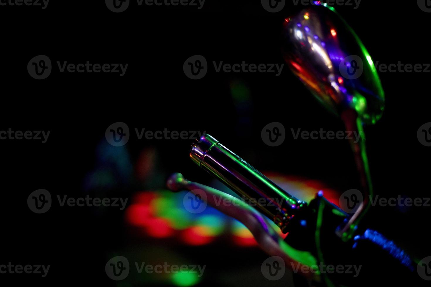 Motorcycle details in colored light. Transport at disco. Light on object. photo