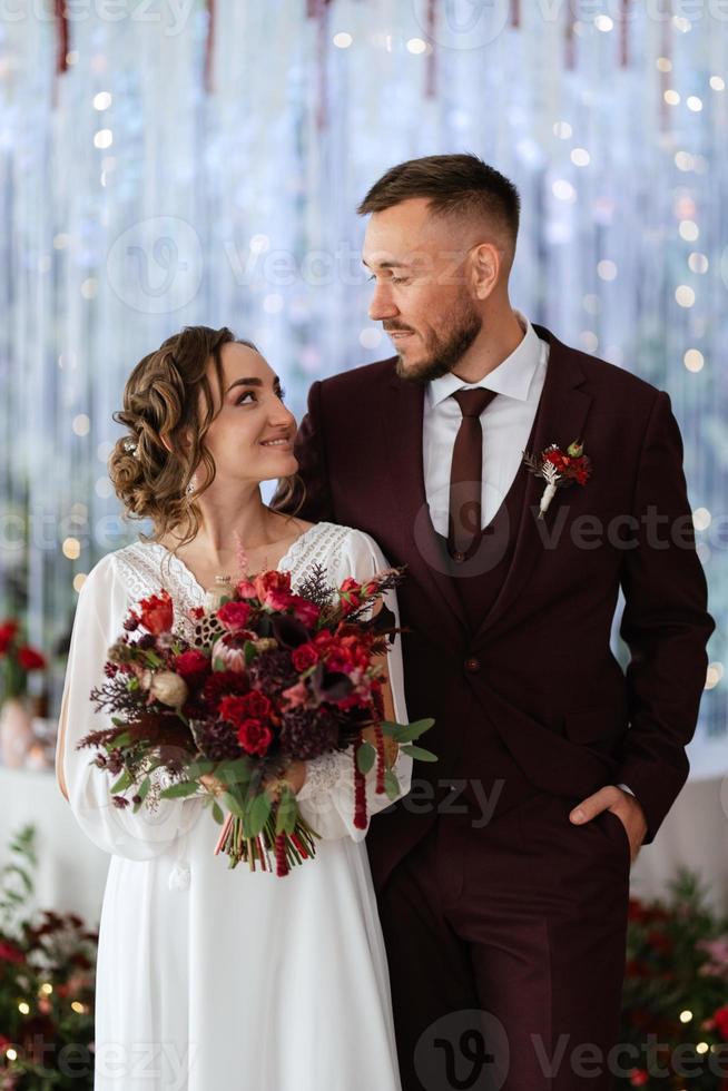 portrait of a young couple of newlyweds in wedding looks photo