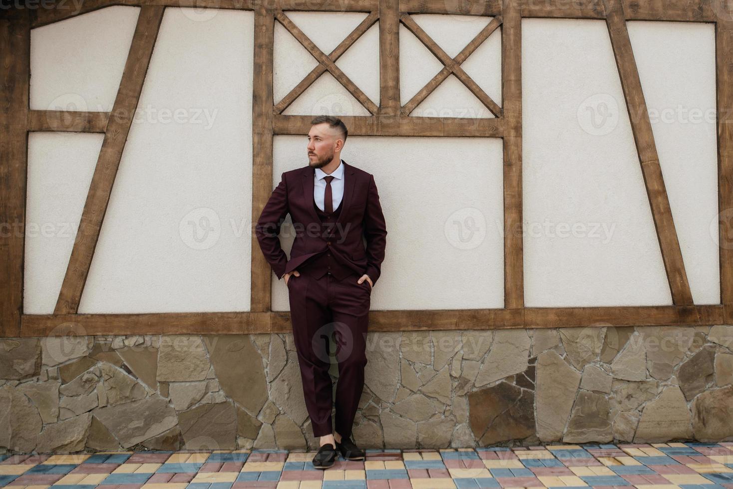 portrait of smiling groom with beard photo