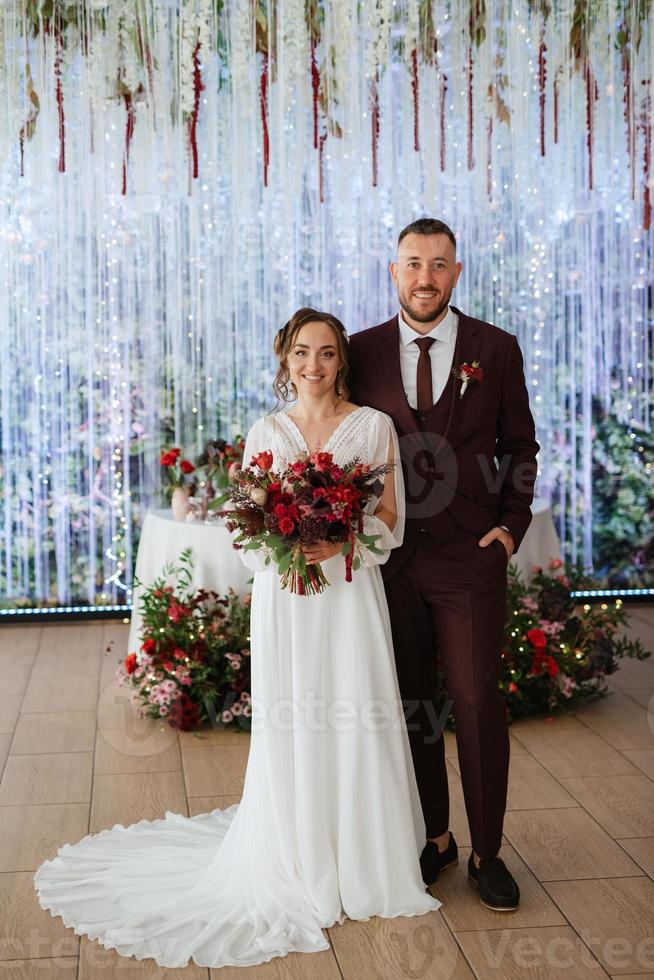 portrait of a young couple of newlyweds in wedding looks photo