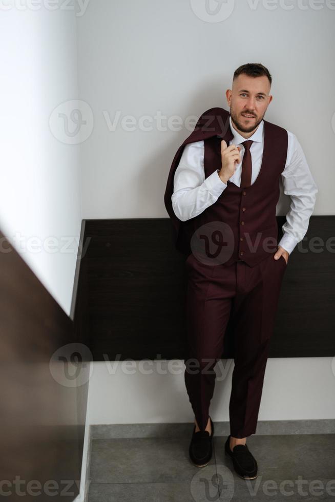 portrait of smiling groom with beard photo