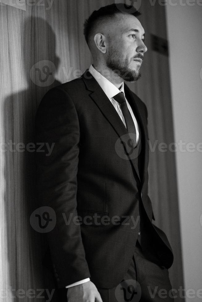 portrait of smiling groom with beard photo