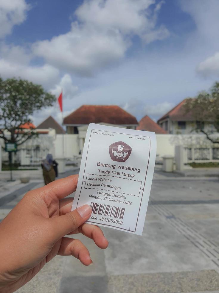 Yogyakarta, Indonesia in November 2022. A hand is holding a ticket to enter the Fort Vredeburg Museum. photo