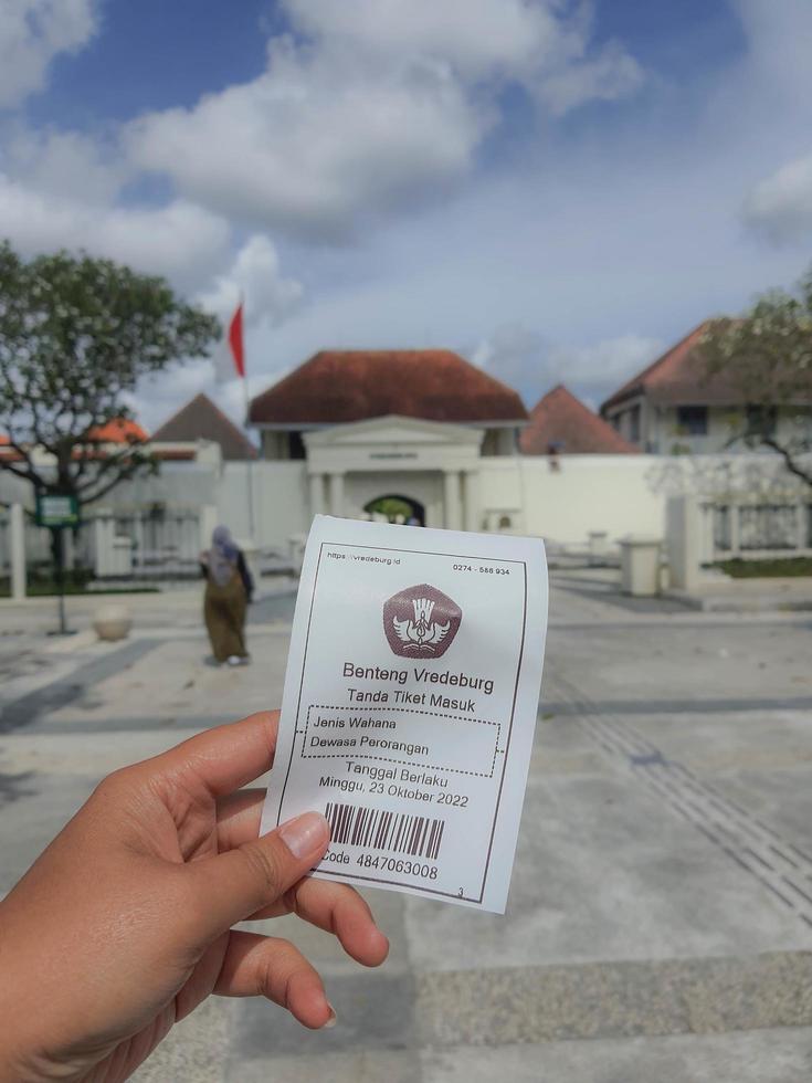 Yogyakarta, Indonesia in November 2022. A hand is holding a ticket to enter the Fort Vredeburg Museum. photo