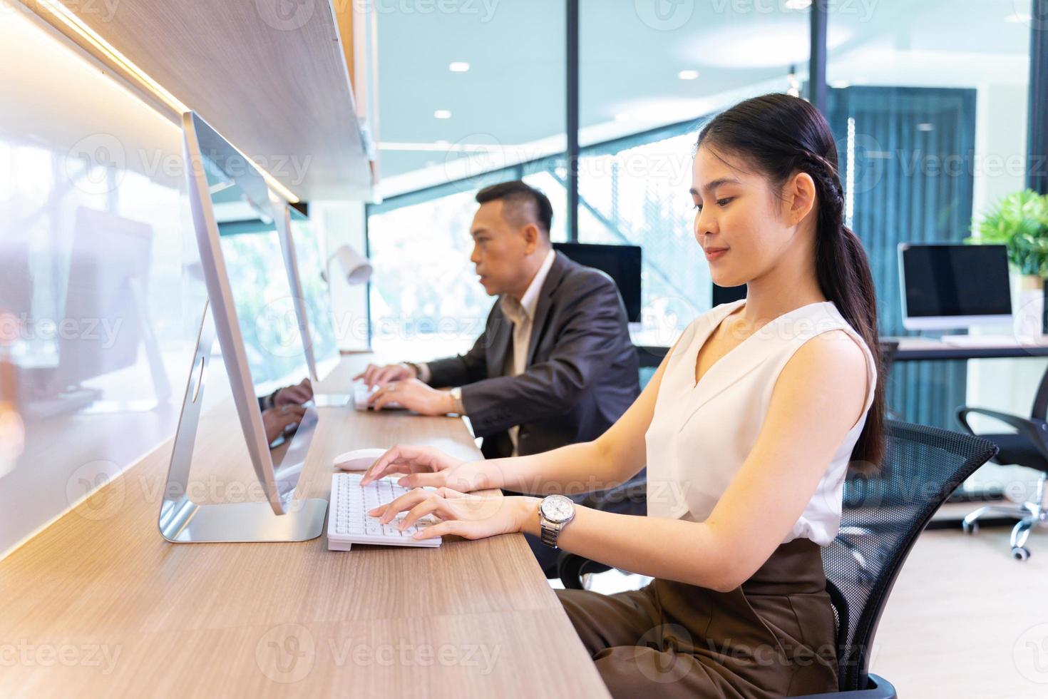 Asian businesswoman in formal suit working in modern luxury office using computer for business and education photo