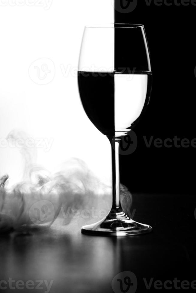 a glass of water and smoke on a black and white background photo