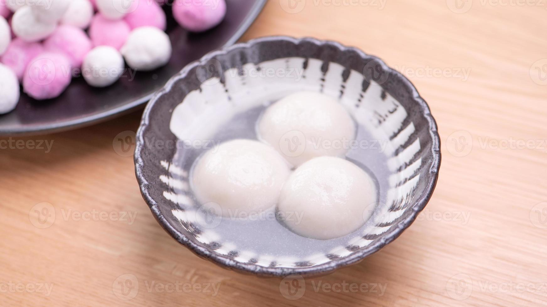 Tang yuan, tangyuan, yuanxiao in a small bowl. Delicious asian traditional festive food rice dumpling balls with stuffed fillings for Chinese Lantern Festival, close up. photo