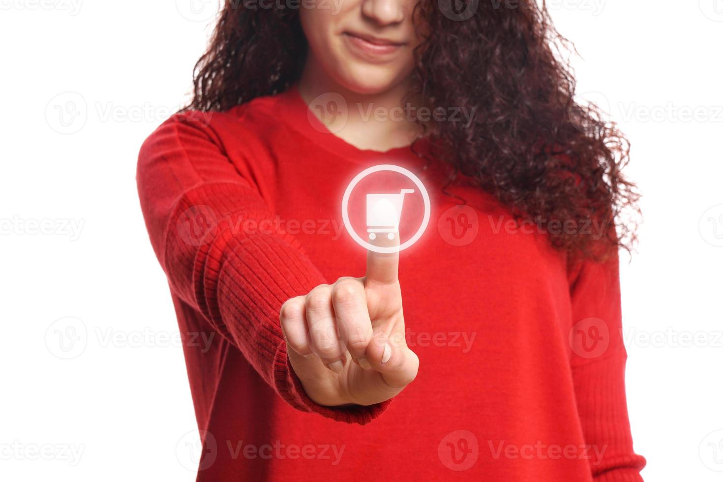 girl pushing virtual button with shopping cart icon photo