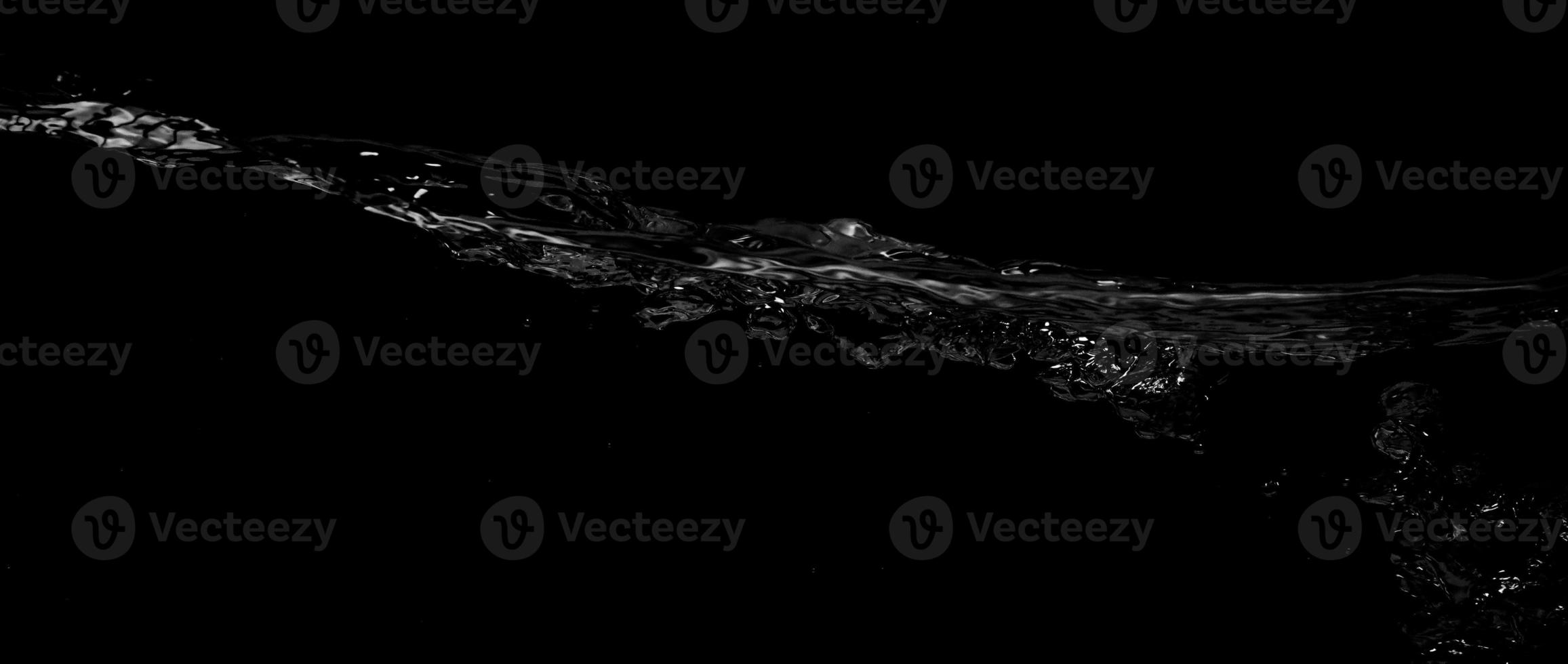 Liquid suface line between underwater and above water with black background. photo