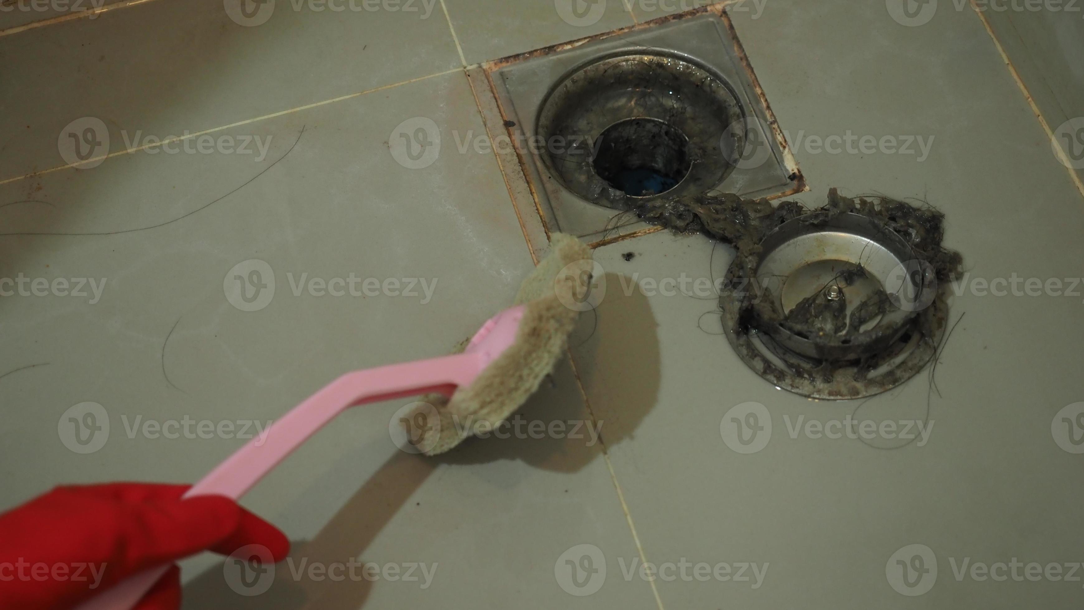 Drain cleaning. Clogged and dirty sewer pipes floor drain. Full of hair