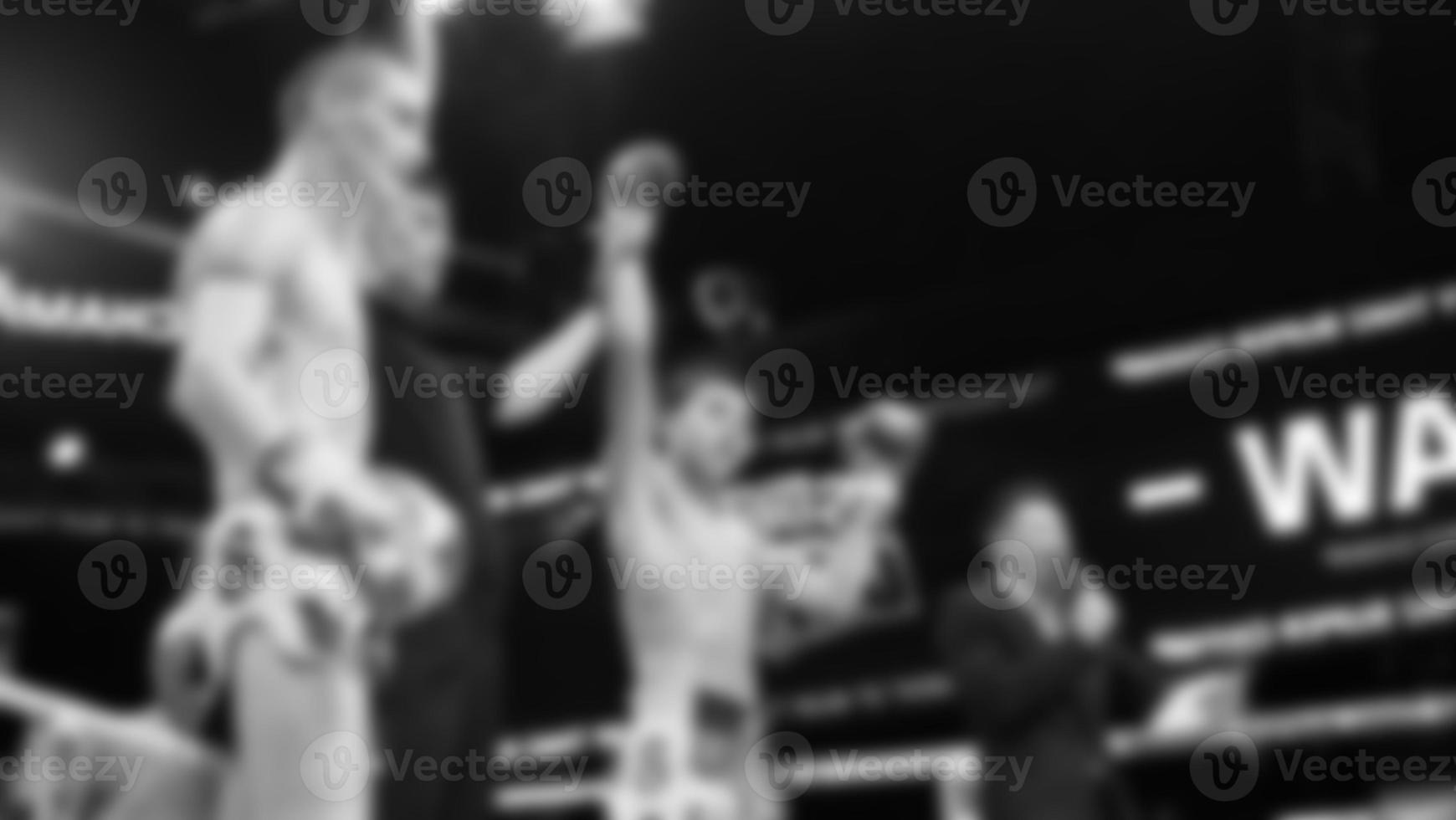 Blurred images black and white photo style of Thai boxing or Muay Thai or Kickboxing which local and foriegn boxer are fighting on the ring at indoor stage as martial art sport. Muay Thai Kick boxing