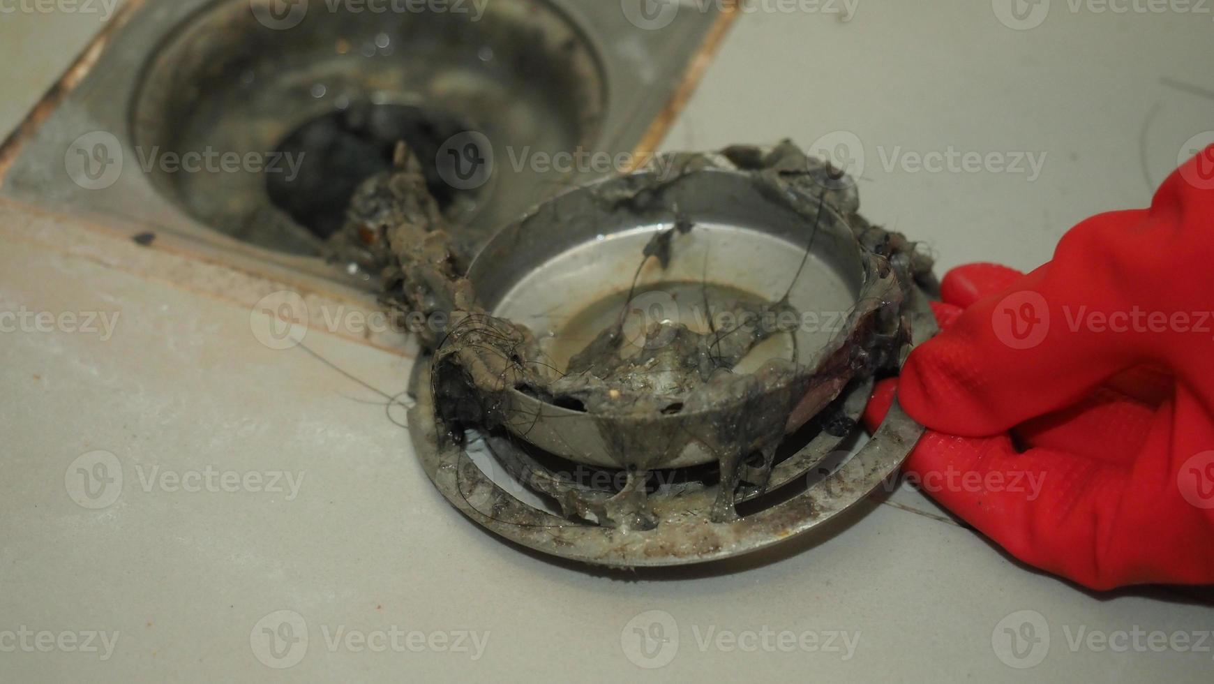 Drain cleaning. Clogged and dirty sewer pipes floor drain. Full of hair