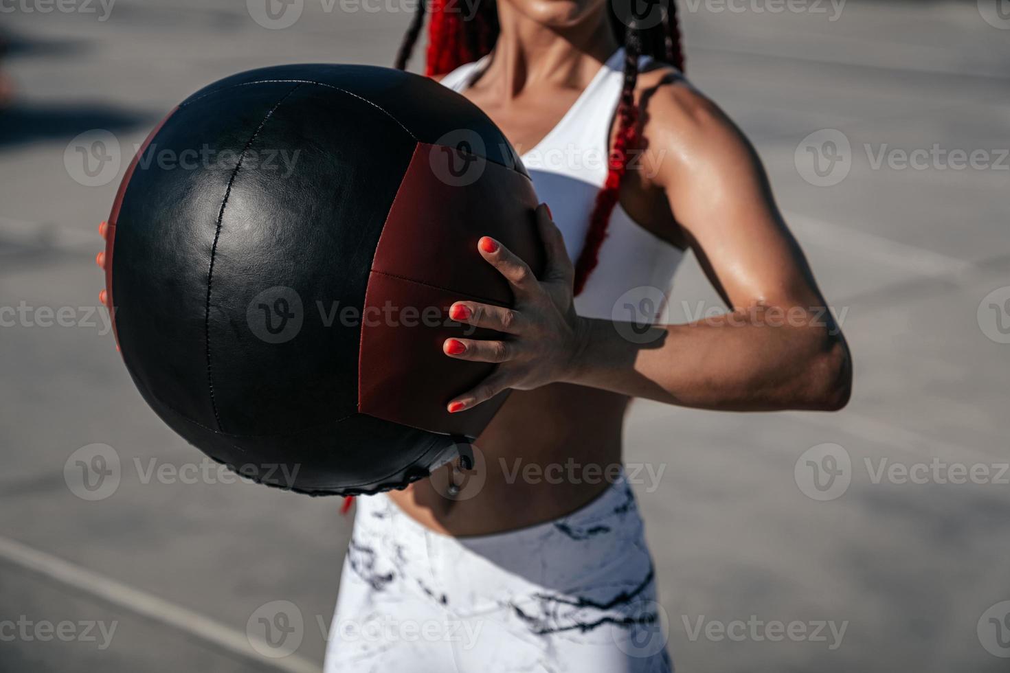 Hands close up. Athletic woman with med ball. Strength and motivation.Photo of sporty  woman in fashionable sportswear photo