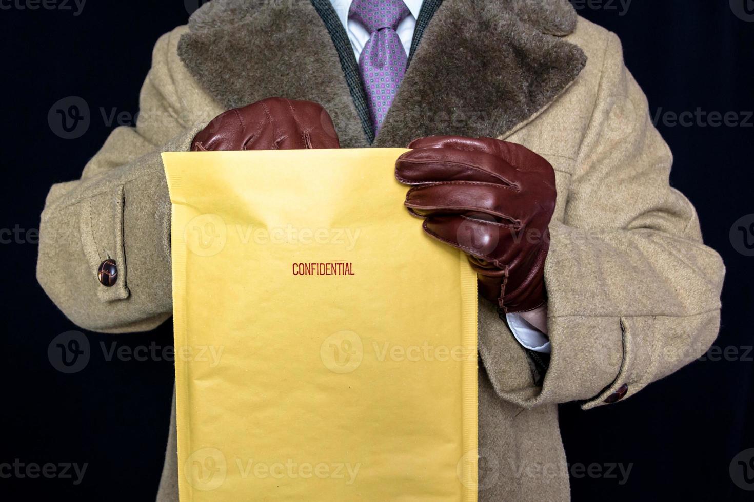 Portrait of Man in Fur Coat and Leather Gloves Reaching Into Confidential Envelope. Film Noir Secret Agent Spy. Identity Theft and Crime. photo