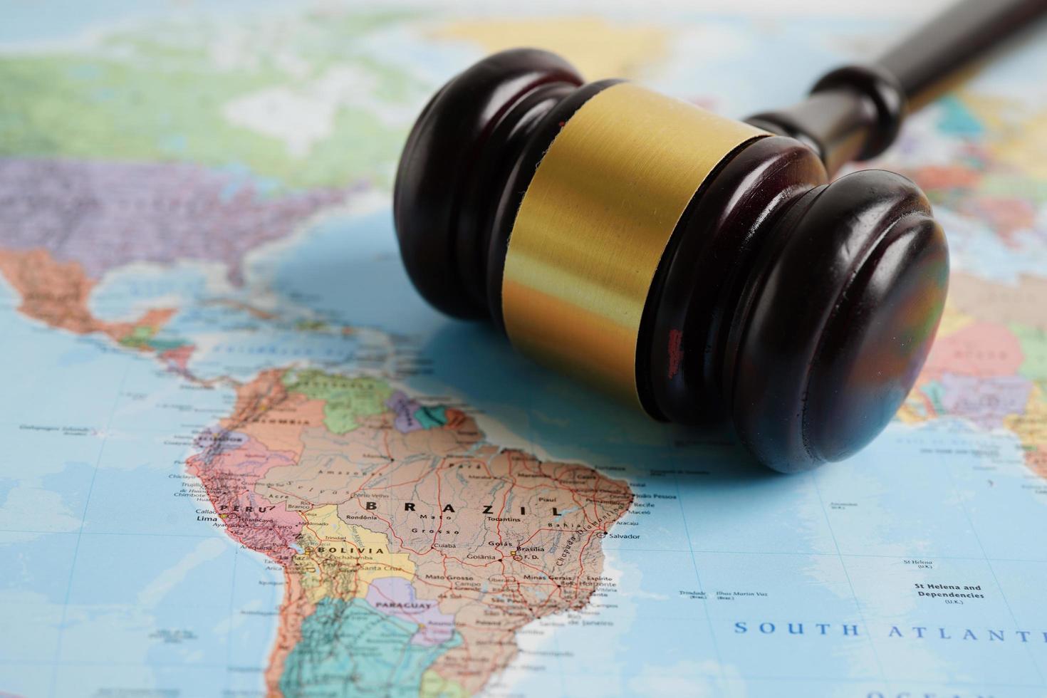 Bangkok, Thailand - May 15, 2022 Judges gavel on world map. photo