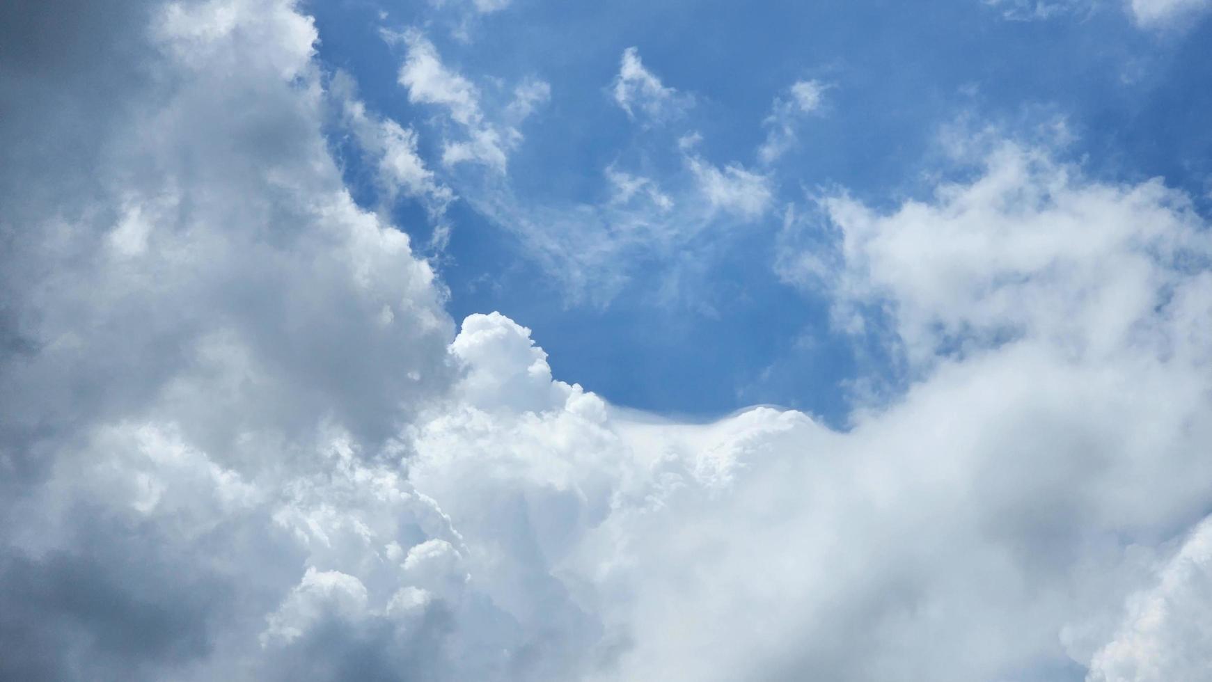Cumulus Clouds In A Blue Sky During Day Time. Natural Sky Background and Wallpaper photo