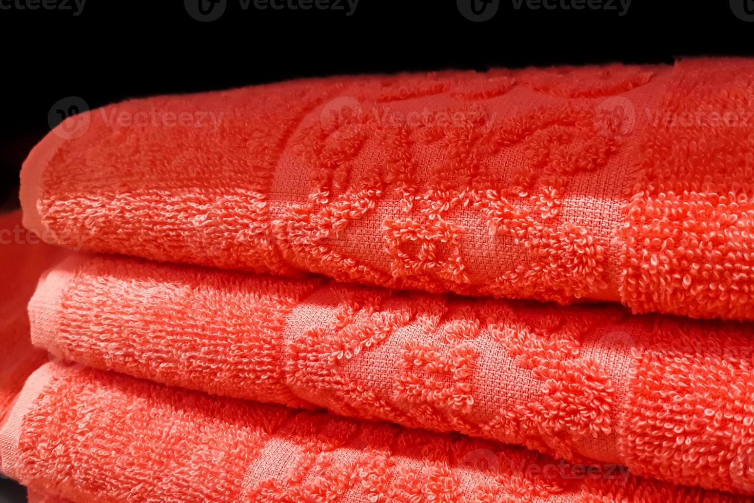 Stack of bath towels. Home textiles for spa treatments. Soft fluffy fabric. photo