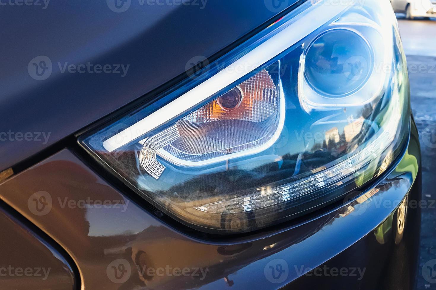 Car headlight close up. Modern lighting devices of luxury car. photo