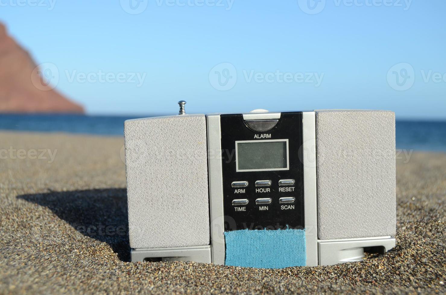 Old radio clock at the beach photo