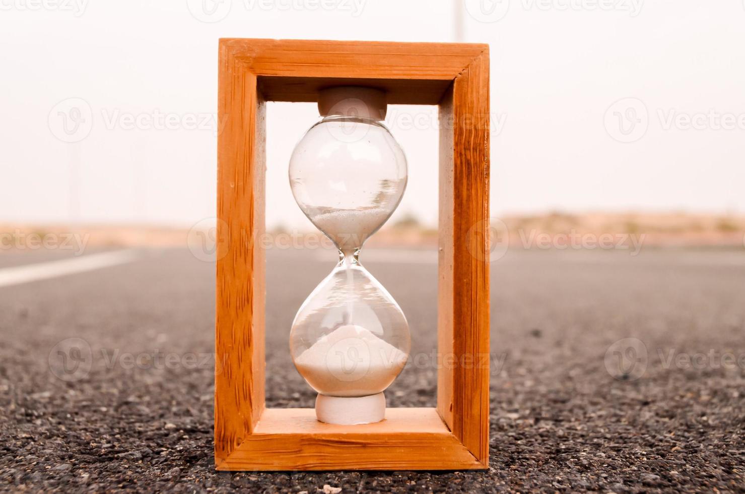 Hourglass on the ground photo