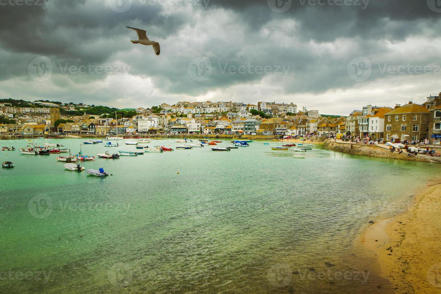 Dramatic cloudscape and scenic panorama of beach of St Ives coastal town, Cornwall, England photo