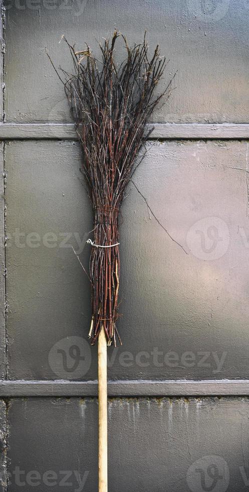old broom on a wooden handle photo