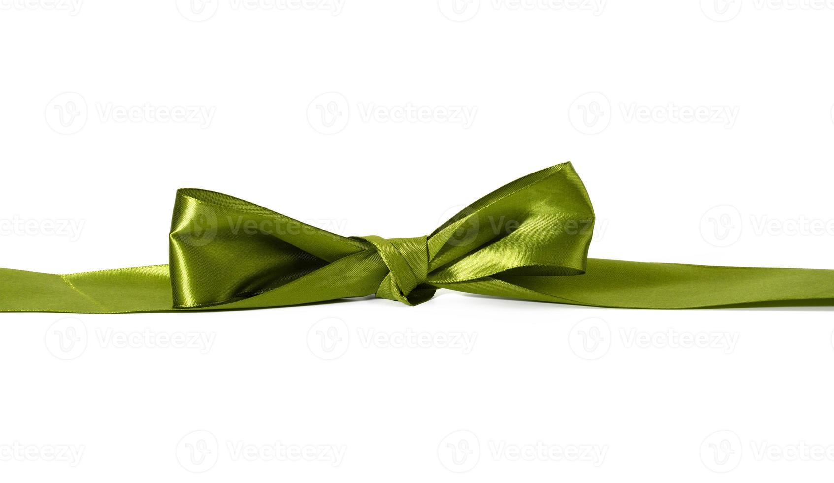 knotted bow made of green silk ribbon on a white background, decor for wrapping gifts photo