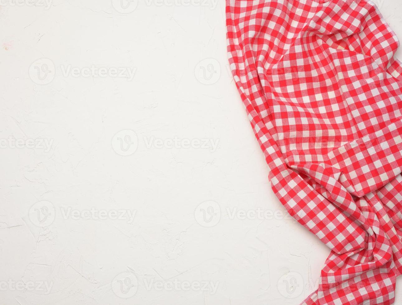 folded cotton red white checkered napkin on a white background photo