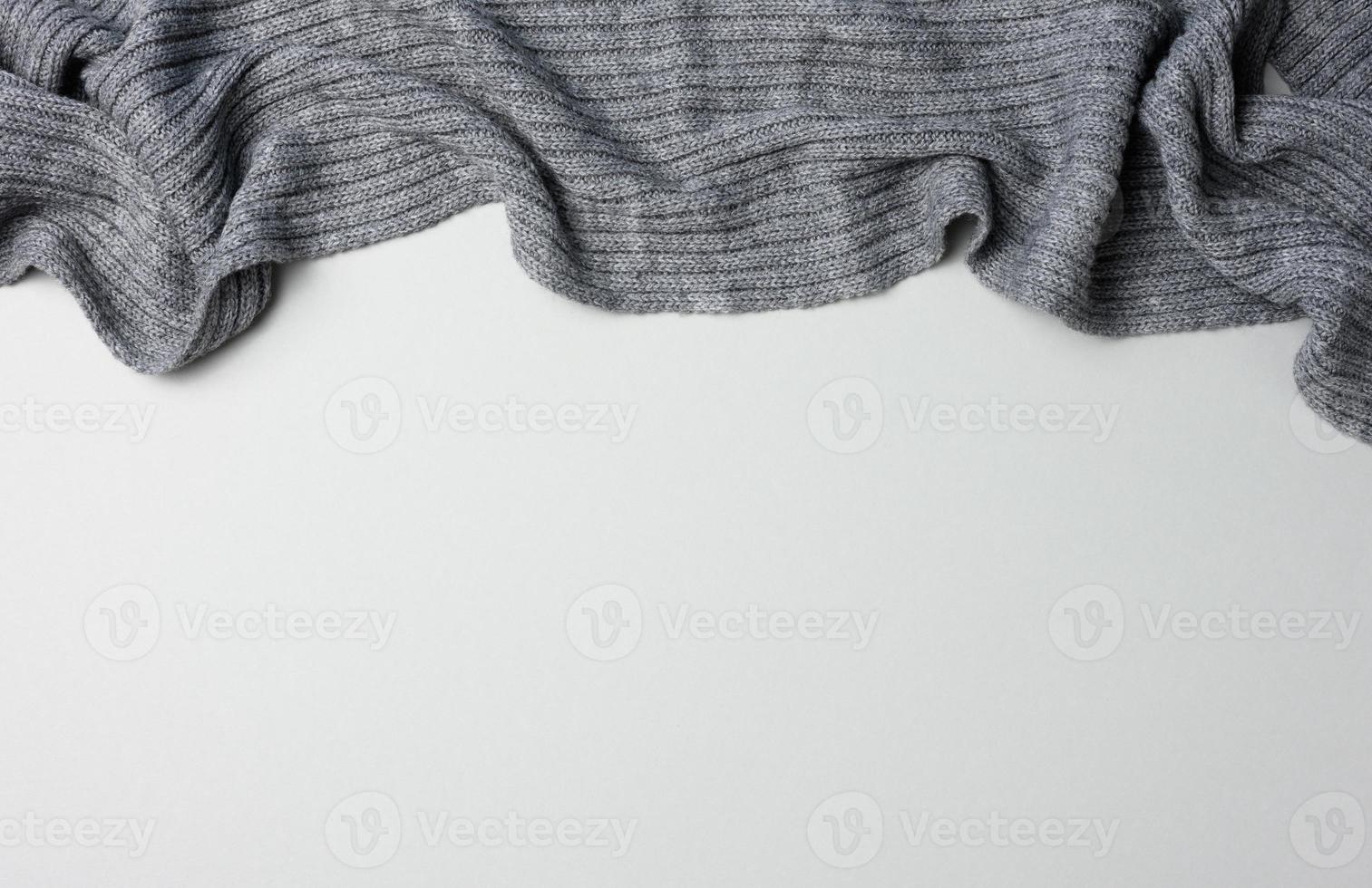 gray knitted fabric on a gray background, top view photo