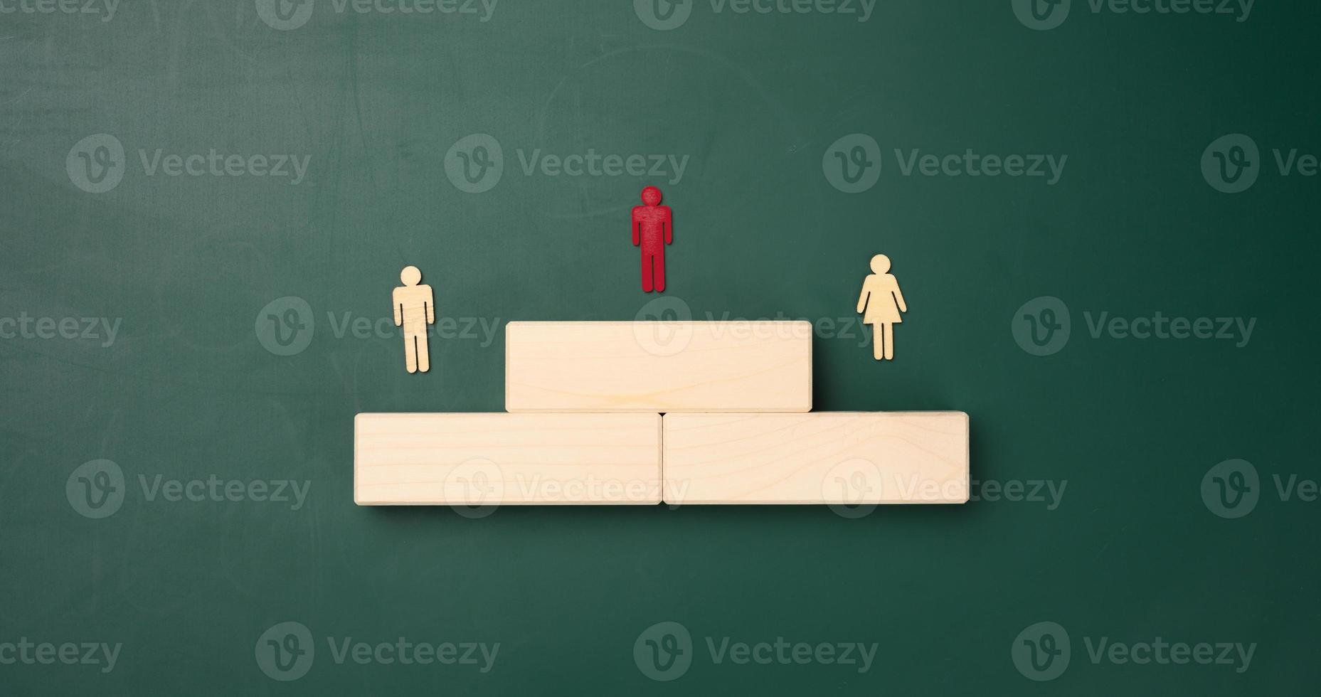 a podium made of wooden blocks and figurines of men. Career growth concept and goal achievement, reward for effort photo