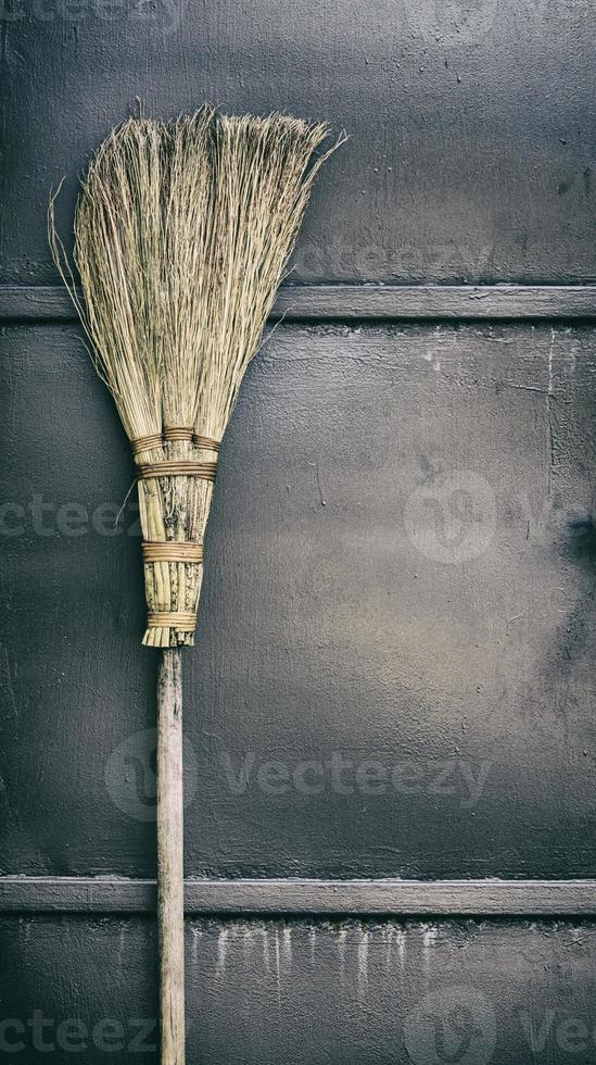 old broom on a wooden handle photo