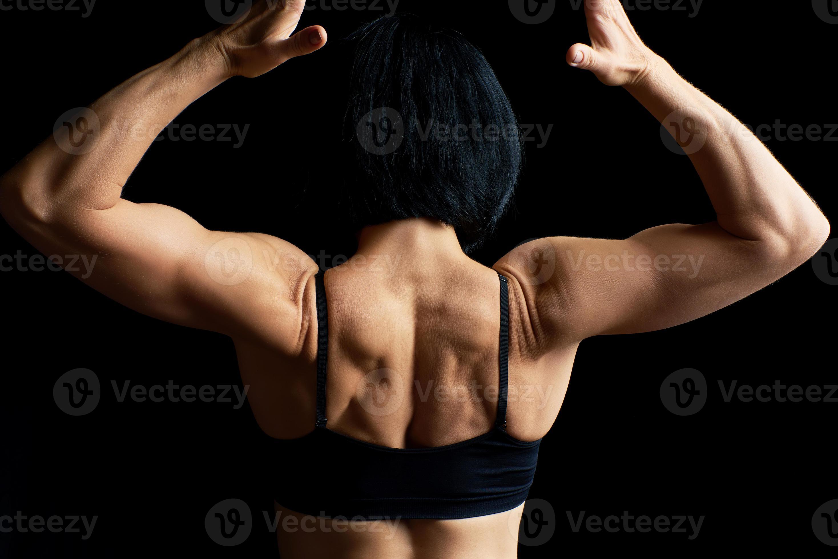 Woman Flexing Her Muscles From Back Stock Photo, Picture and