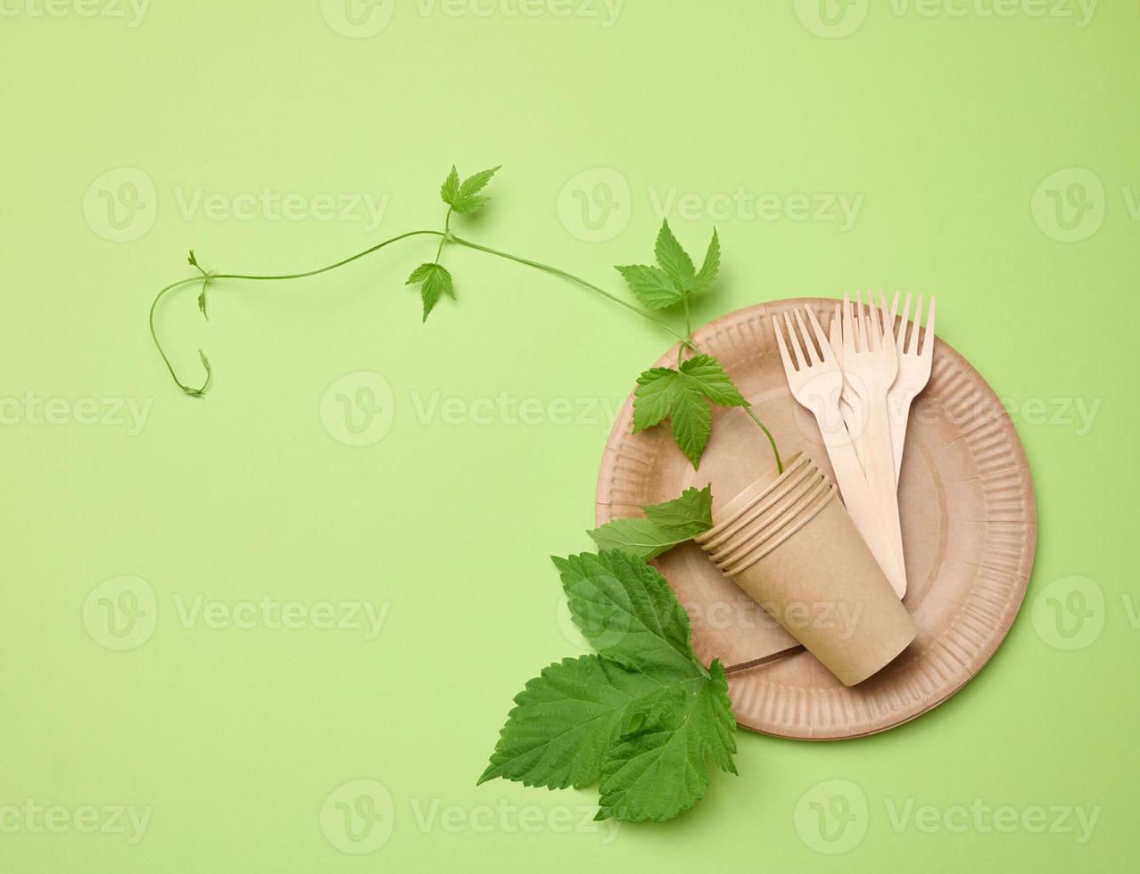 Brown paper plates and disposable cups. The concept of avoiding plastic dishes photo