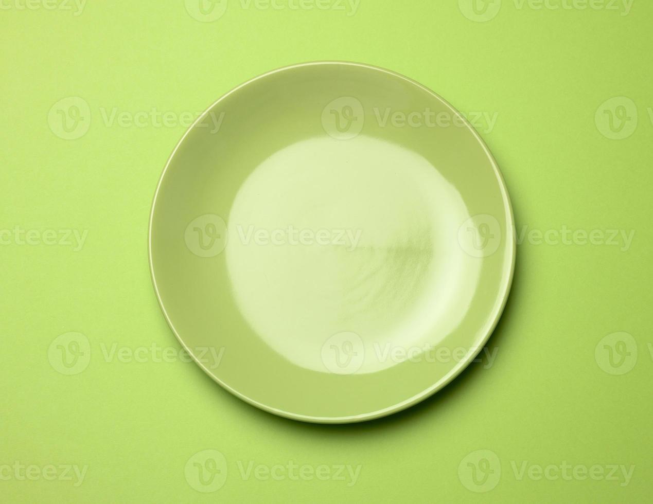empty round green plate for main courses on a green background photo