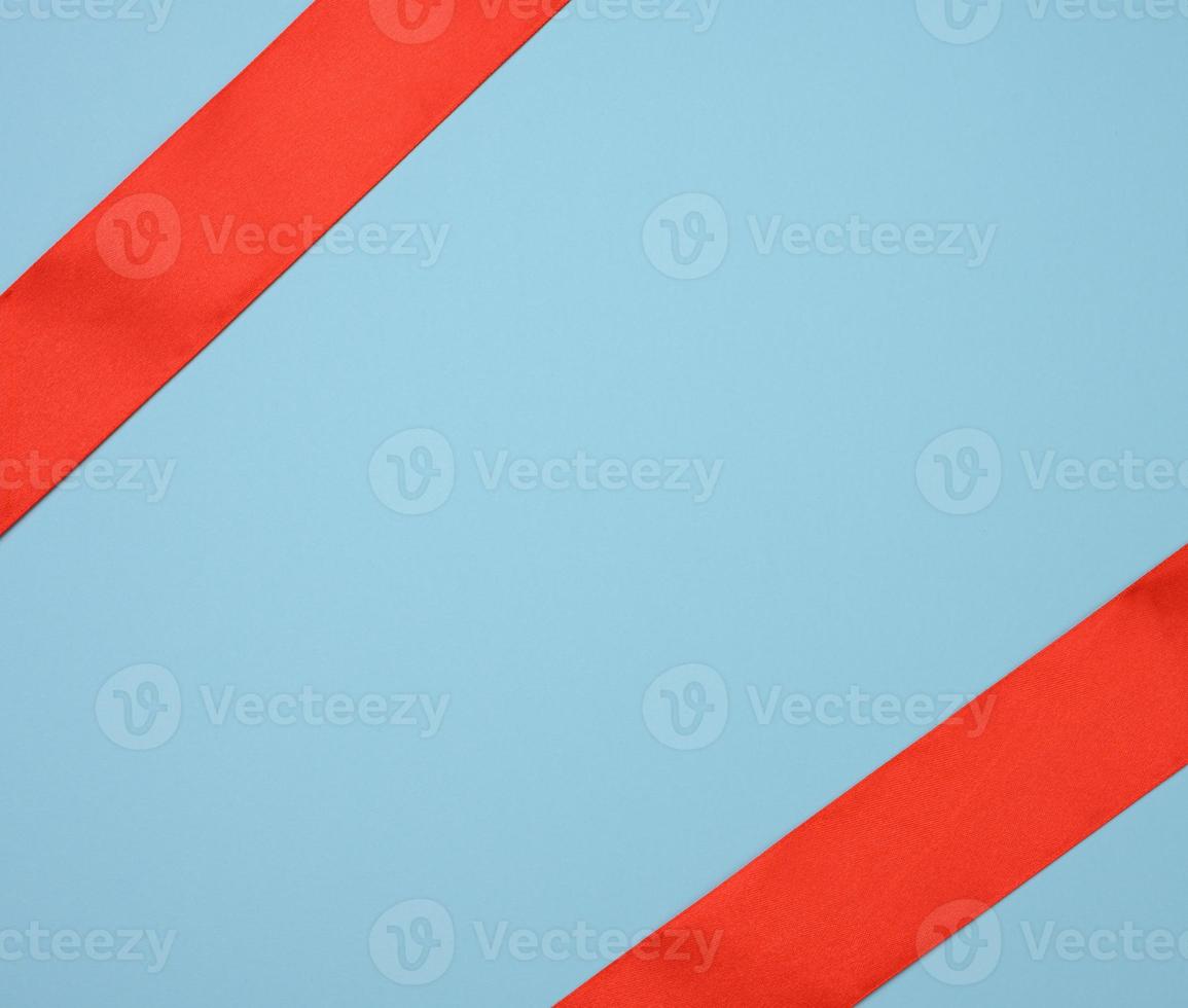 red silk ribbon on a blue background, festive backdrop photo
