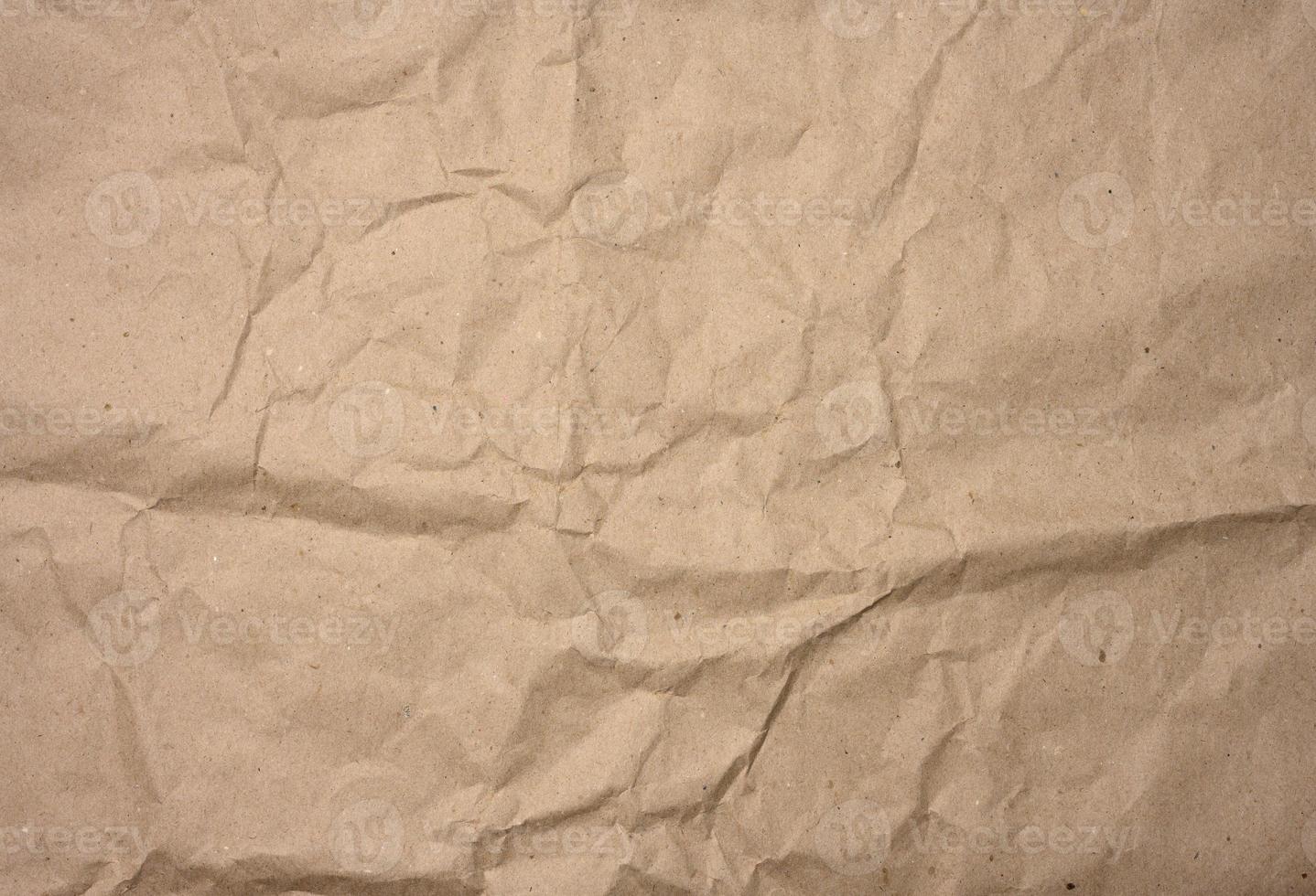 crumpled blank sheet of brown wrapping kraft paper, vintage texture for the designer photo