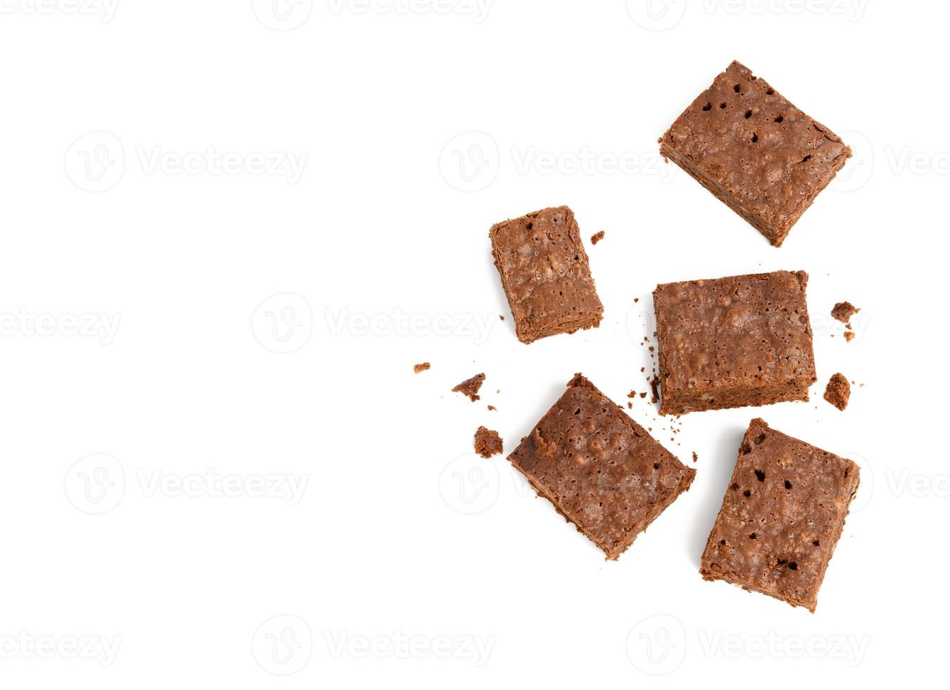 stack of baked chocolate brownie pieces with walnut isolated on white background photo