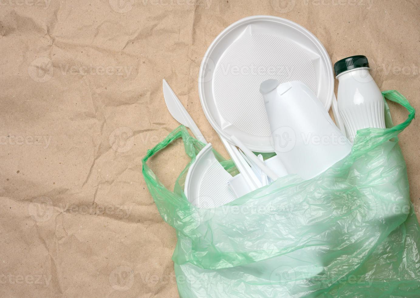 plastic waste from life on the background of brown kraft paper, environmental pollution photo