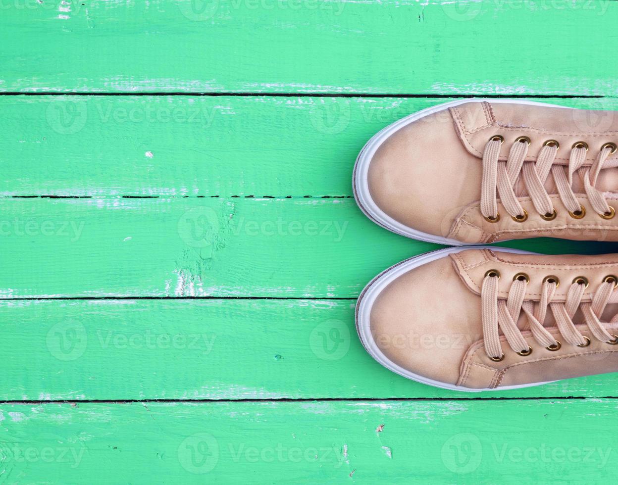 top view of a pink pair of female leather sneakers photo
