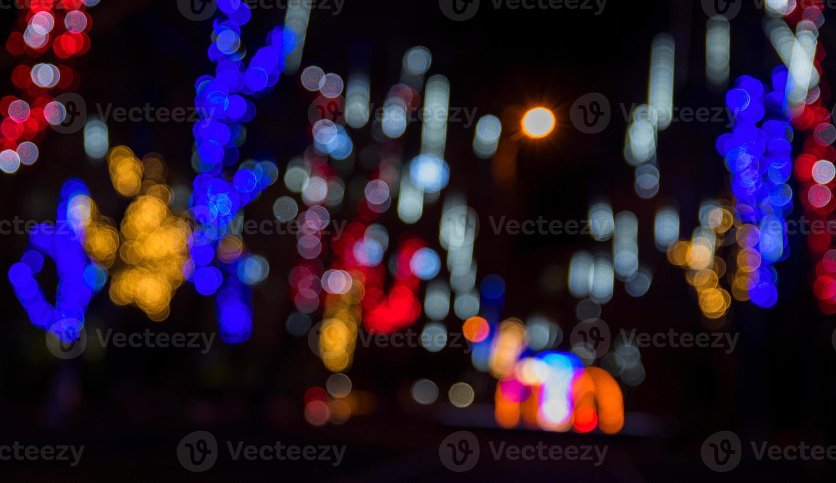 Blurred background of the street at night with luminous electric garlands photo