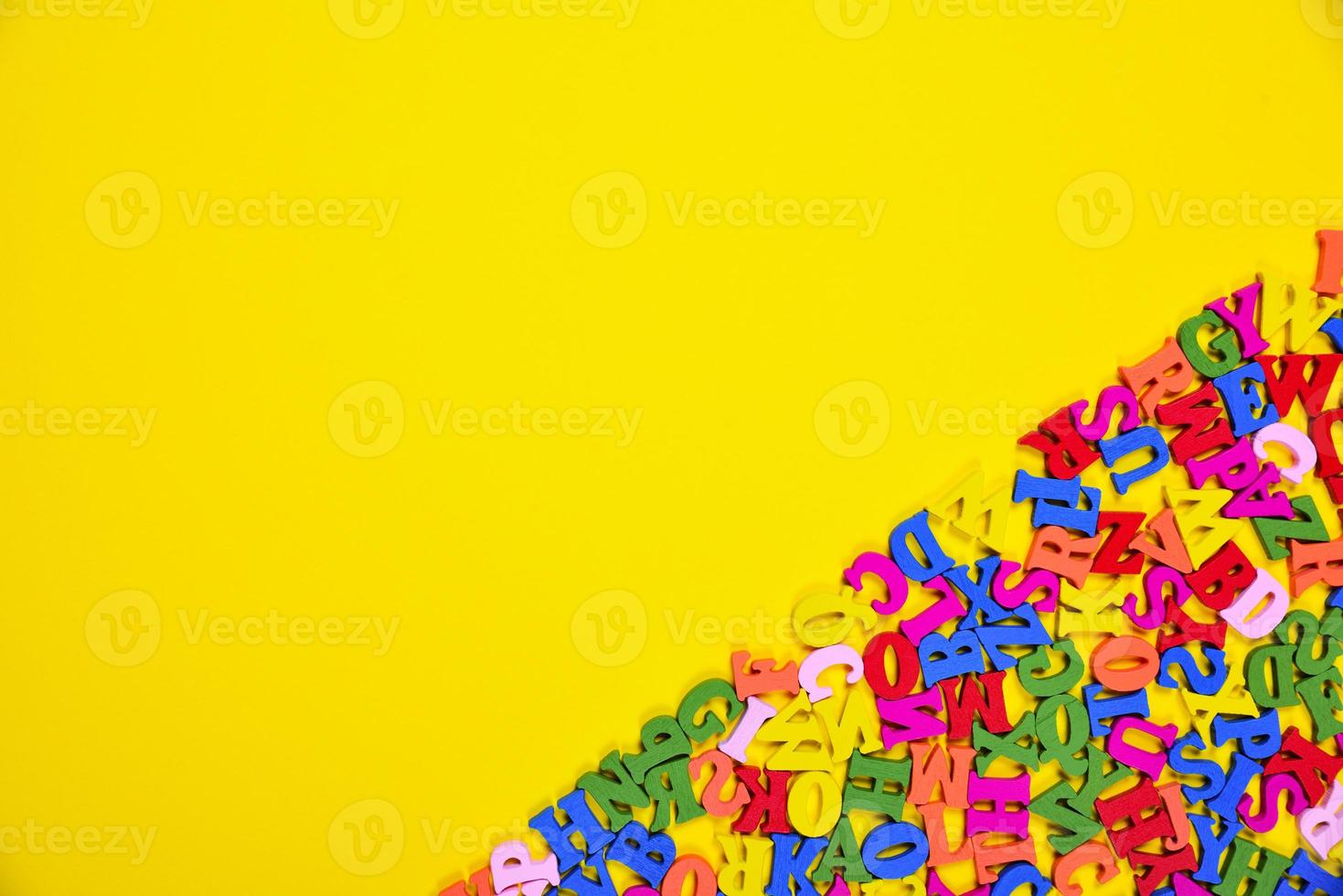 Abstract yellow background with multicolored letters photo