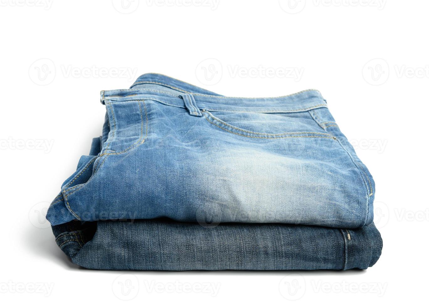 folded blue men's jeans on a white background photo