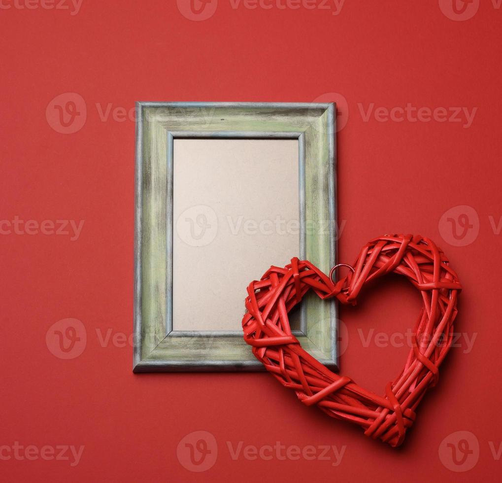 empty rectangular blank wooden frame, red background photo