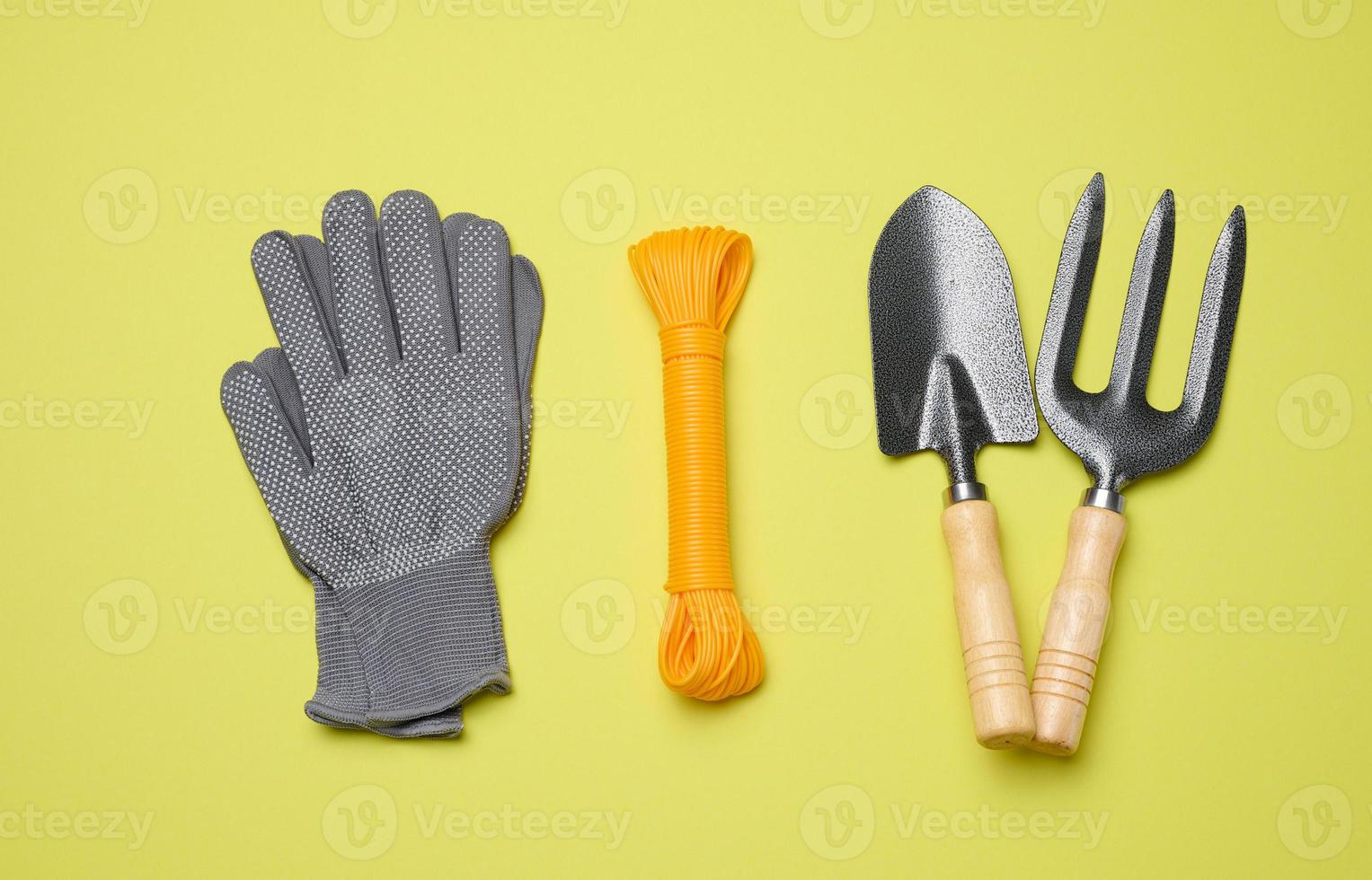 Garden tools for processing beds in the garden on a green background photo