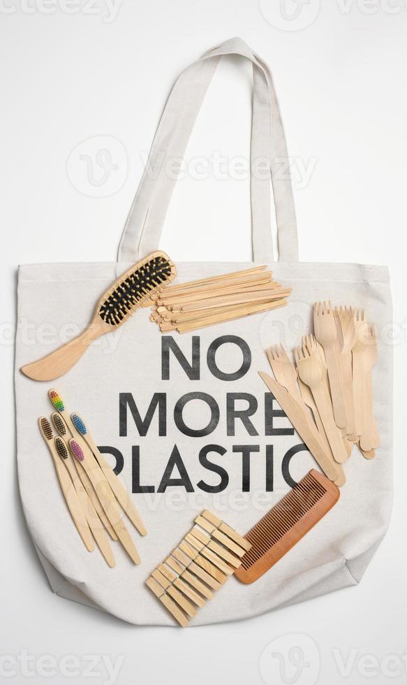 toothbrush, comb, clothespin and other wooden items on a white background, top view photo