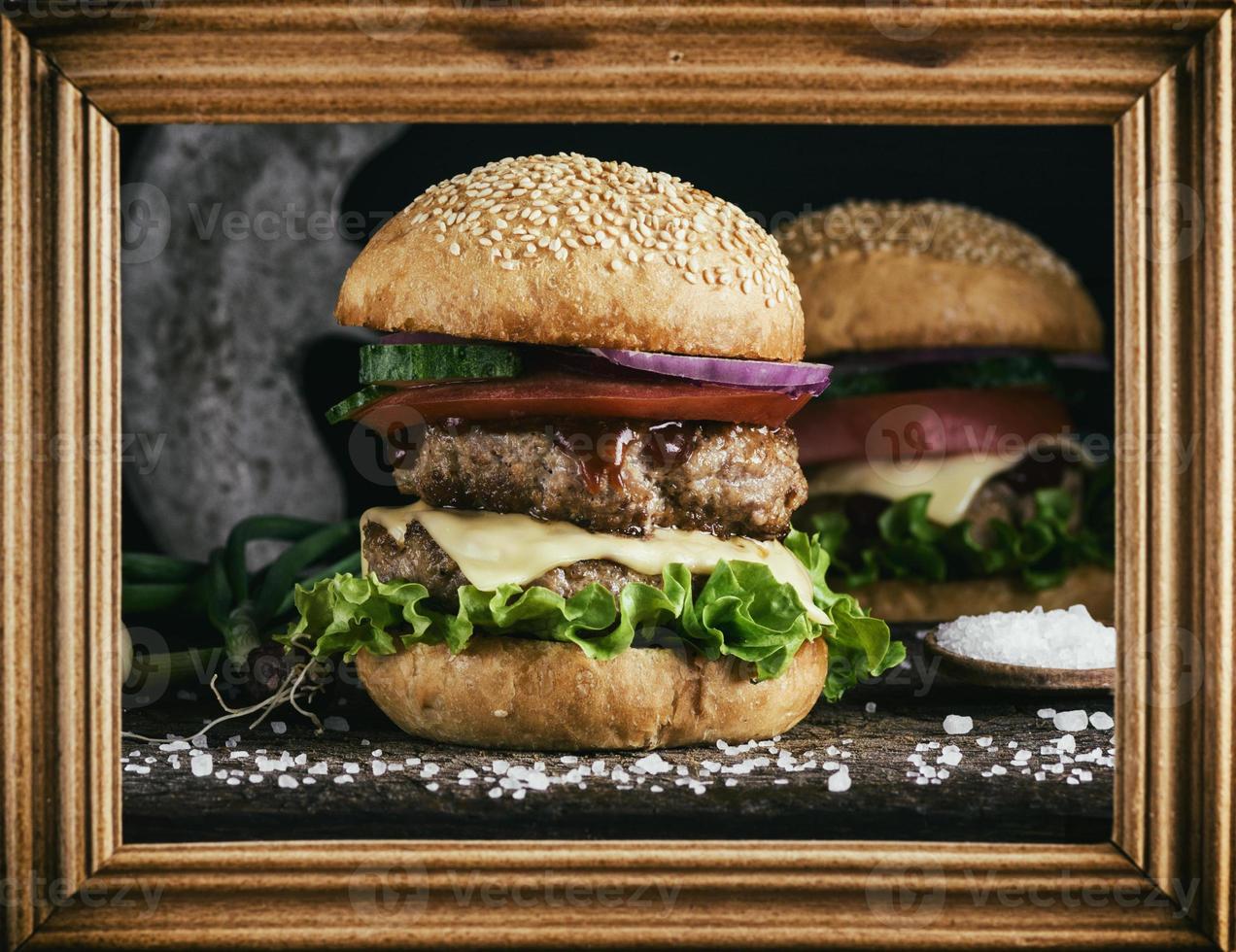 double burger with vegetables and cheese photo