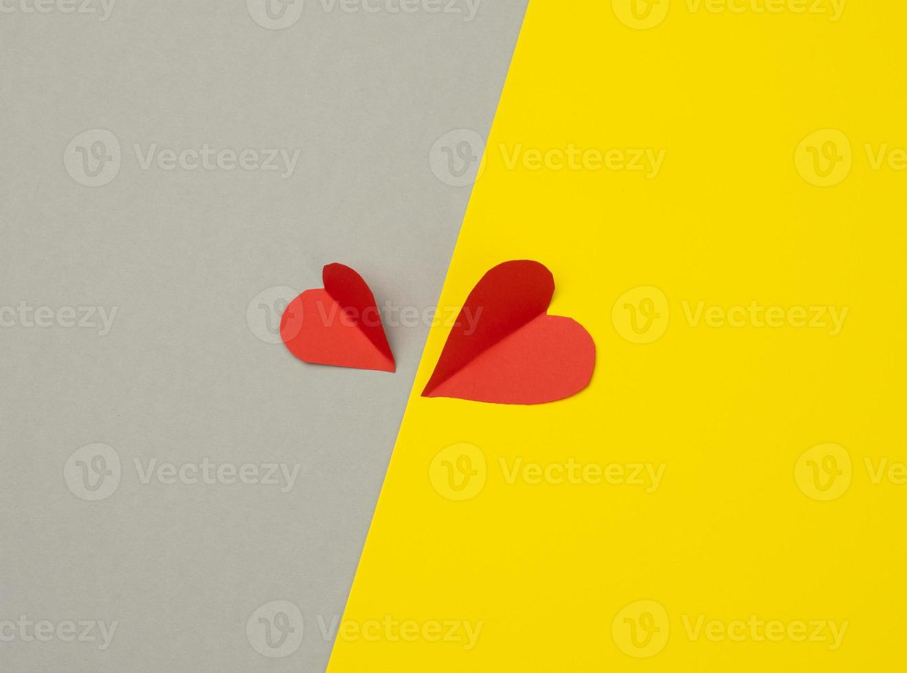 two paper hearts on a yellow-gray background photo