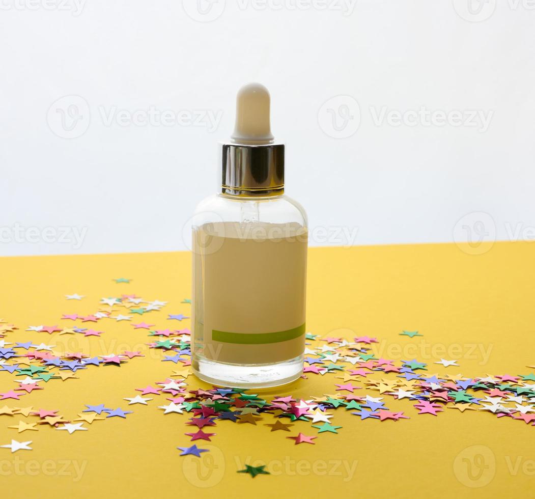white glass bottle with a pipette and a empty white label. Container for cosmetics, serum and oil. Mockup skincare product photo