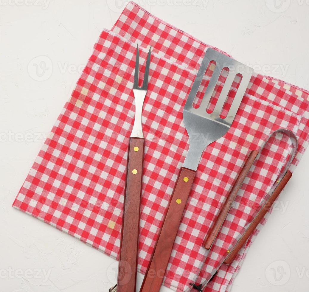 metal kitchen items with wooden handles for barbecue on white background photo