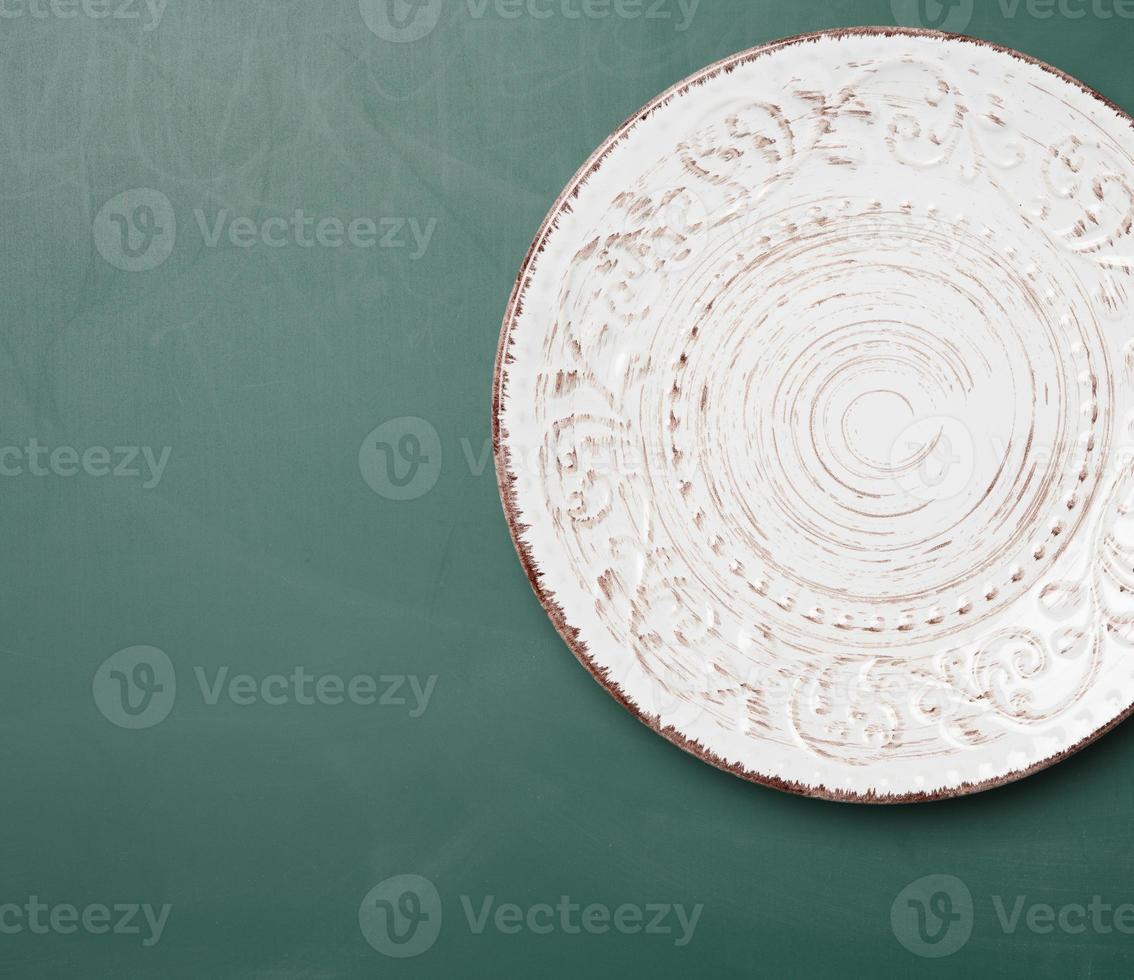 empty round plateplate for main courses on a green background photo